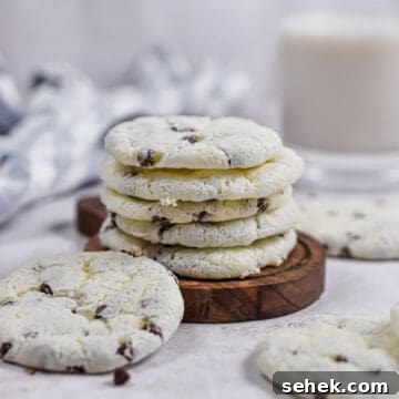 The cookies are stacked on a wooden plate.