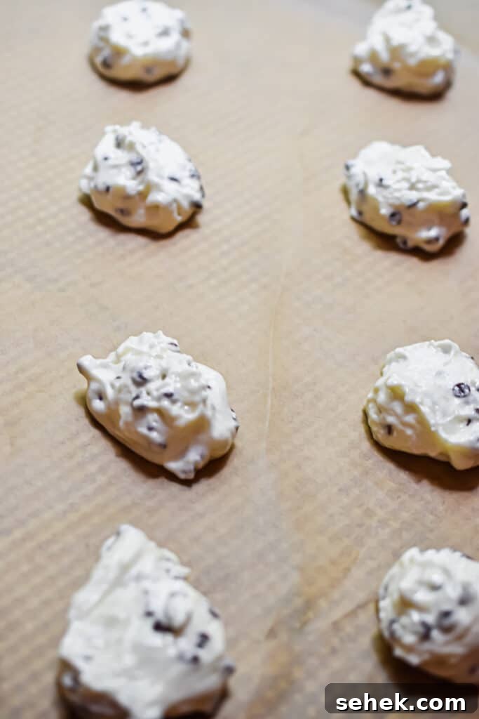 Chocolate Chip Angel Food Cake Cookies: Light, Fluffy Treats 7 The cake batter is scooped onto a parchment lined baking sheet.