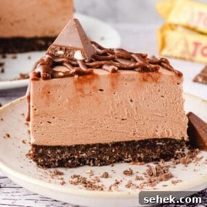 Decadent Toblerone Cheesecake Recipe with Crunchy Chocolate Honeycomb 11 Close up slice of cheesecake on a plate.