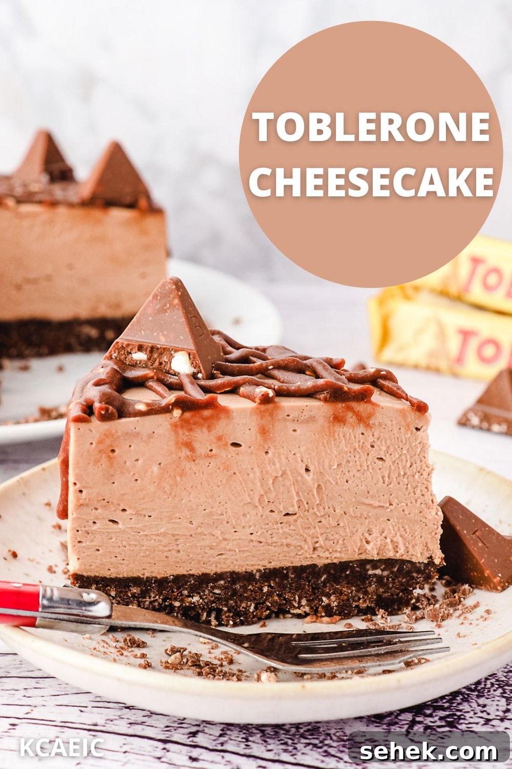 Decadent Toblerone Cheesecake Recipe with Crunchy Chocolate Honeycomb 12 Slice of Toblerone cheesecake on a plate, with rest of cheesecake and more Toblerone in background, with text overlay.