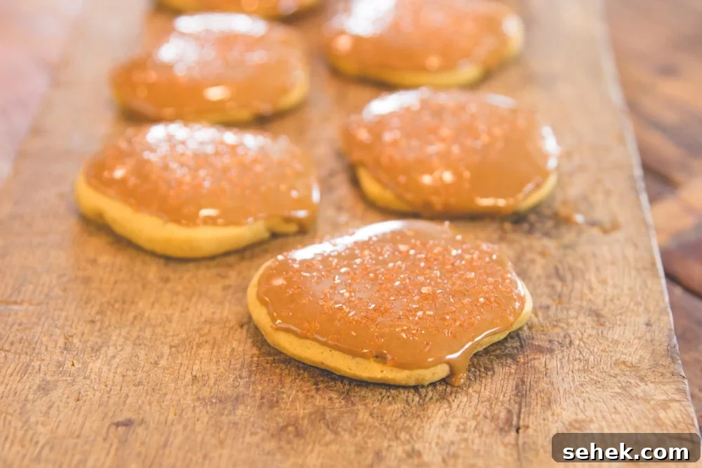 No-Bake Pumpkin Refrigerator Cookies Recipe for Fall Treats 3 A row of pumpkin cookies sits on a wooden block.