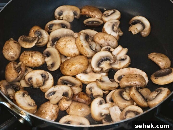 Creamy Mushroom Gravy Recipe for Steaks and Mashed Potatoes 8 Sautéed mushrooms in a pan.