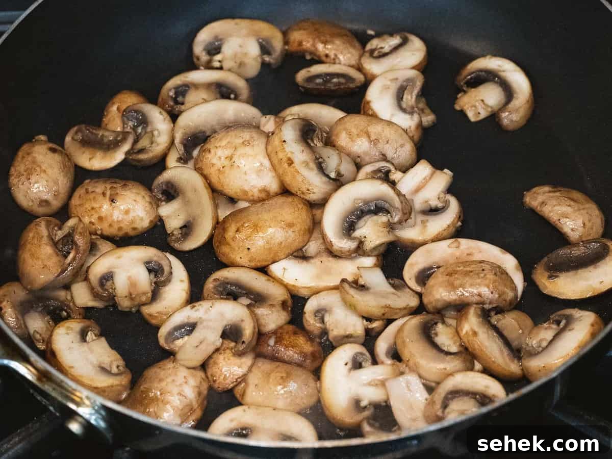 Creamy Mushroom Gravy Recipe for Steaks and Mashed Potatoes 4 Sautéed mushrooms in a pan.