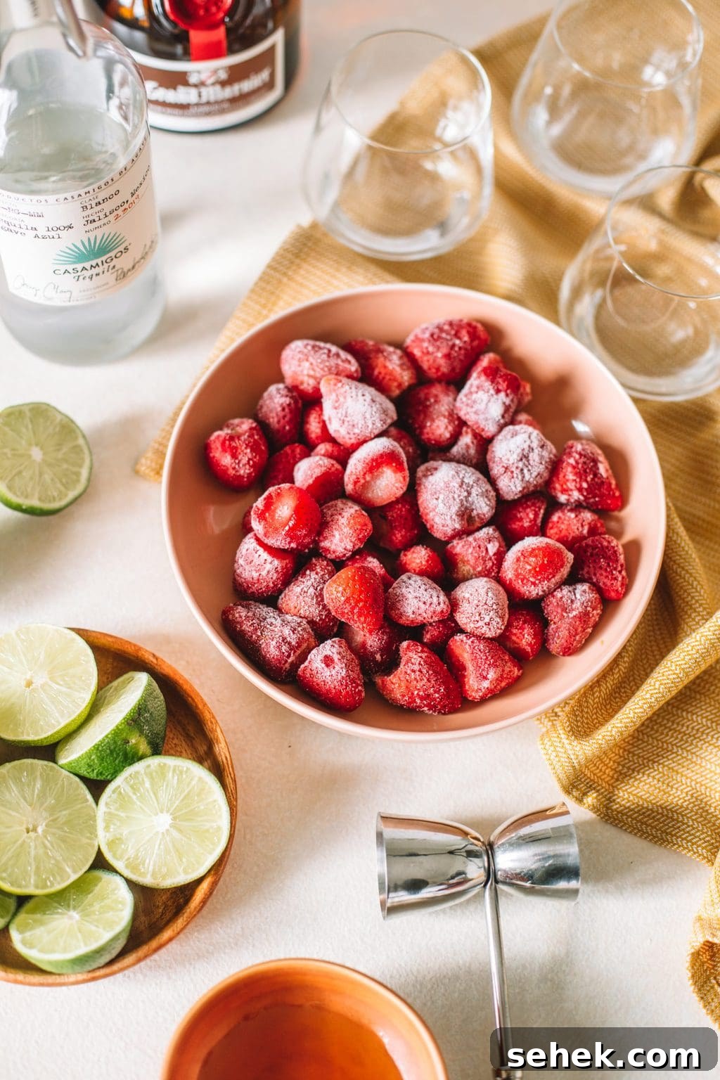 Frozen Strawberry Margarita Recipe: How to Make a Refreshing Frozen Strawberry Margarita 4 tequila, frozen strawberries, limes, jigger, glasses