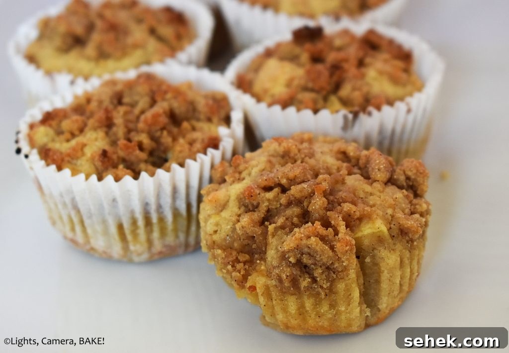 Fluffy Apple Cinnamon Muffins with Streusel Topping 14 Apple cinnamon crumb muffin on a white plate.