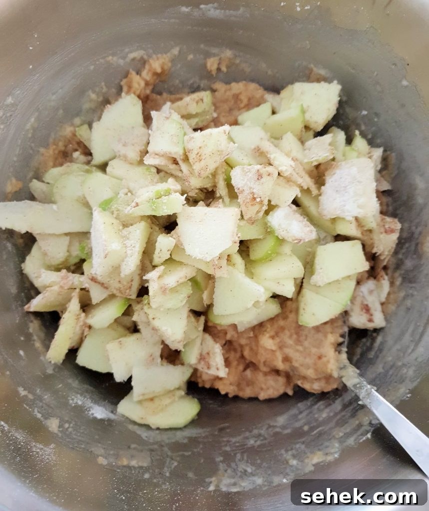 Fluffy Apple Cinnamon Muffins with Streusel Topping 10 Adding apples to batter.