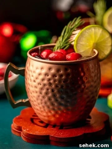 Cranberry moscow mule on a green table.