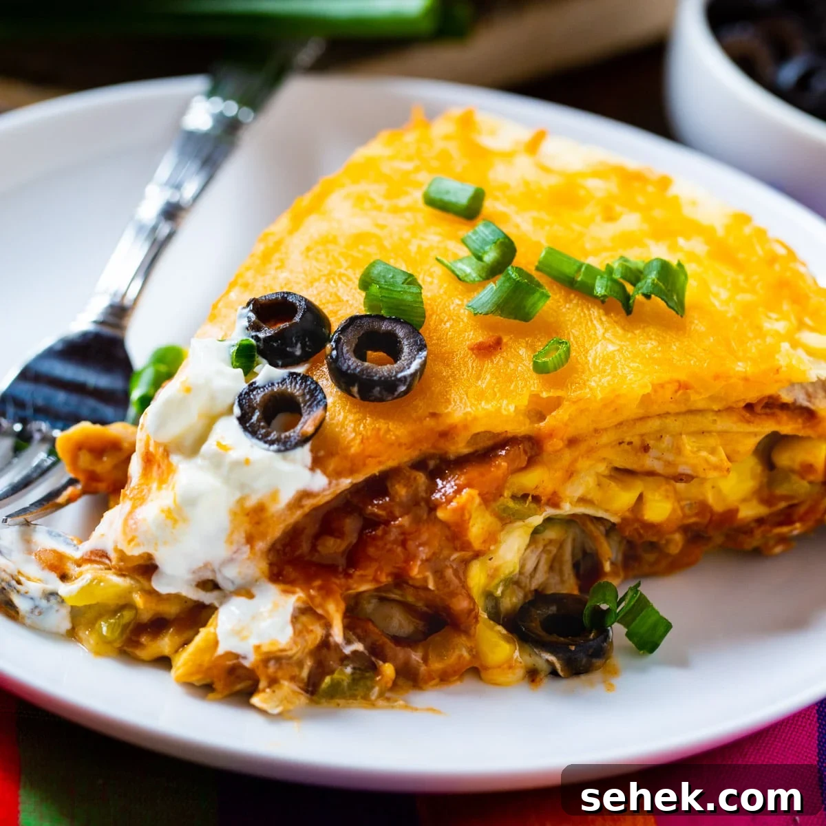One-Pan Chicken Tortilla Pie Recipe for Quick Weeknight Dinners 2 Slice of One Pot Chicken Tortilla Pie on a plate.