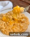 Quick and easy vegetable side dish for dinner made with frozen cauliflower rice, cream cheese, butter, cheddar, milk, and seasoning.