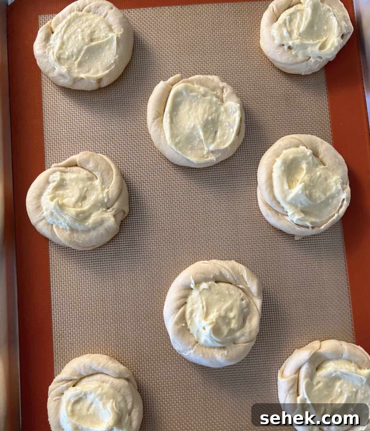 Pillsbury Cream cheese danish with filling on cookie sheet.