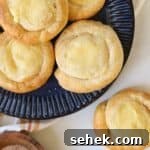 Cream cheese danish made with crescent rolls on a blue plate.