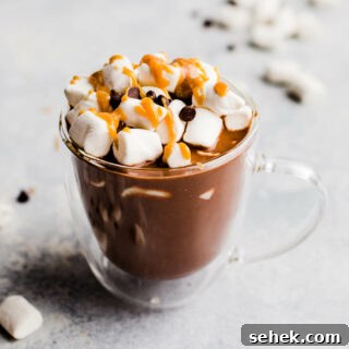 Peanut butter hot chocolate in a clear mug.