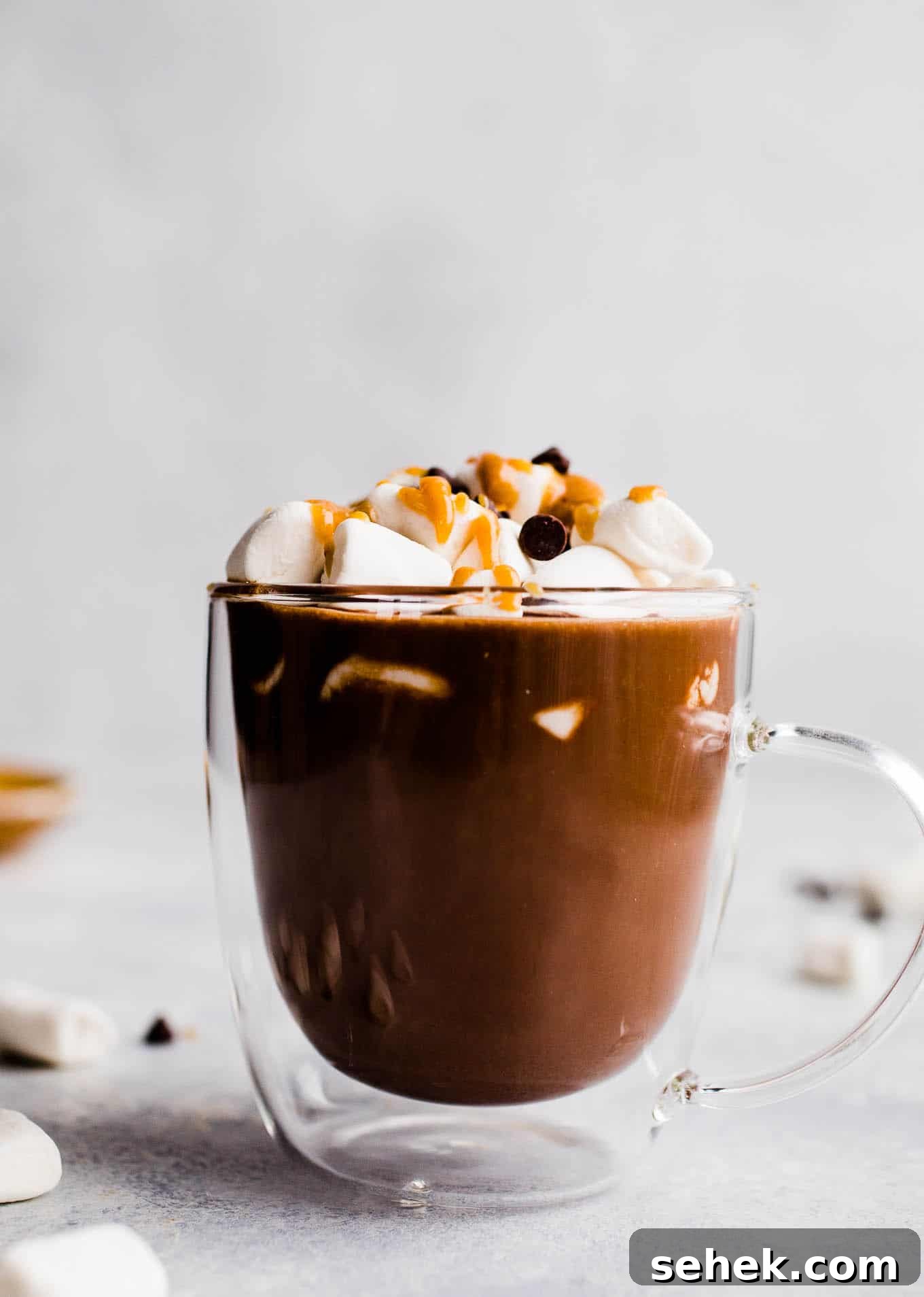 Hot cocoa in a glass mug.