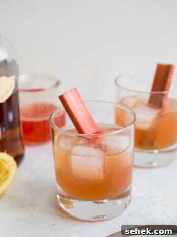 Two bourbon sours in cocktail glasses.