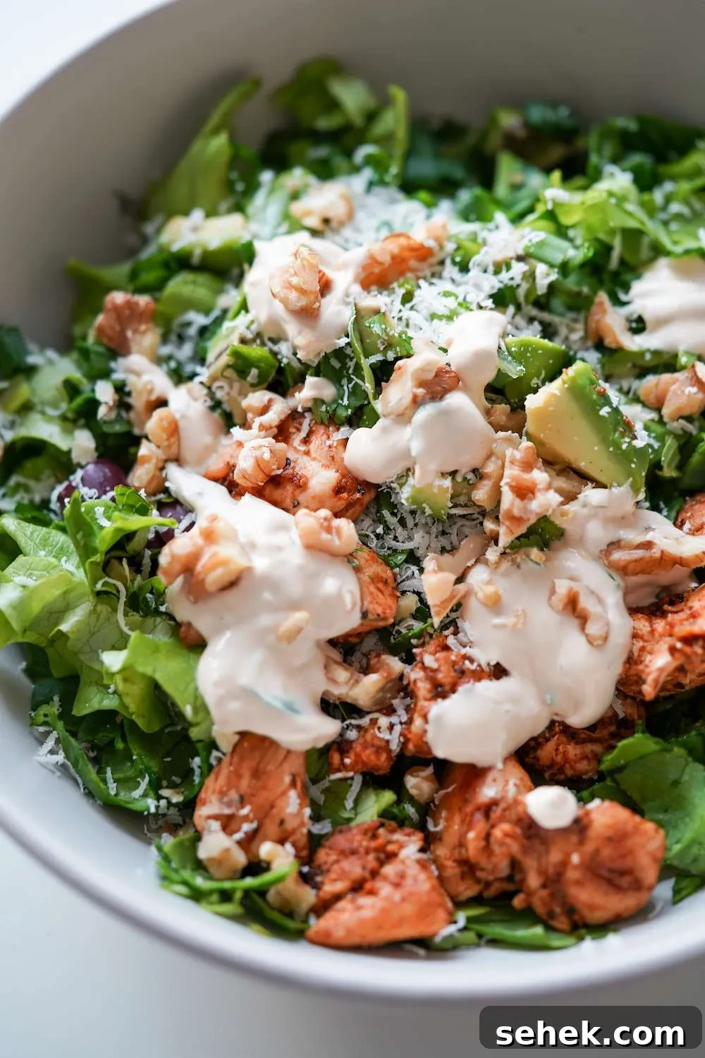This low-carb chicken salad with creamy yogurt dressing is packed with leafy greens and avocado! Add some walnuts and toasted sesame seeds for extra crunch, you do not need croutons! This healthy salad recipe is the perfect way to use chicken breast and it’s high-fiber high-protein and low in carbs, perfect for meal prep too! Enjoy for lunch or dinner!