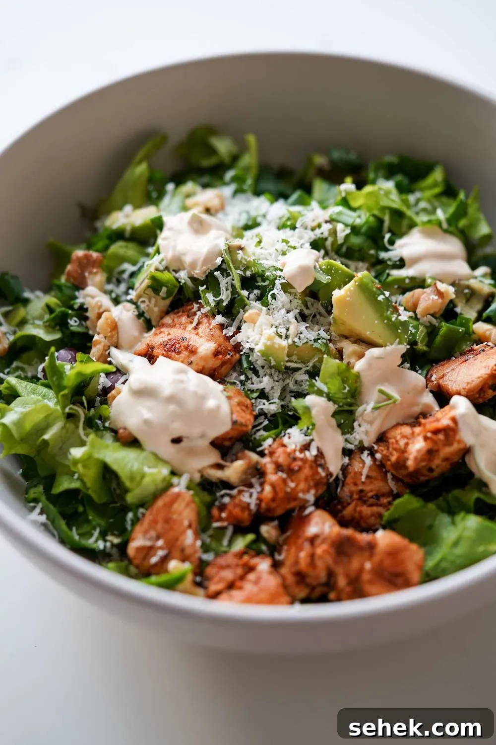 This low-carb chicken salad with creamy yogurt dressing is packed with leafy greens and avocado! Add some walnuts and toasted sesame seeds for extra crunch, you do not need croutons! This healthy salad recipe is the perfect way to use chicken breast and it’s high-fiber high-protein and low in carbs, perfect for meal prep too! Enjoy for lunch or dinner!