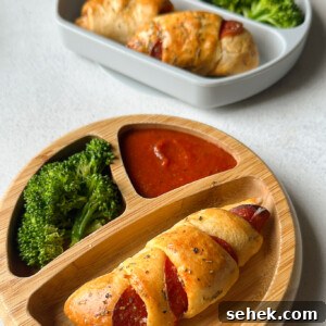 Crescent-Style Pizza Rolls: Gooey Pepperoni Bites Recipe 12 Crescent pizza rolls served with broccoli and marinara sauce.