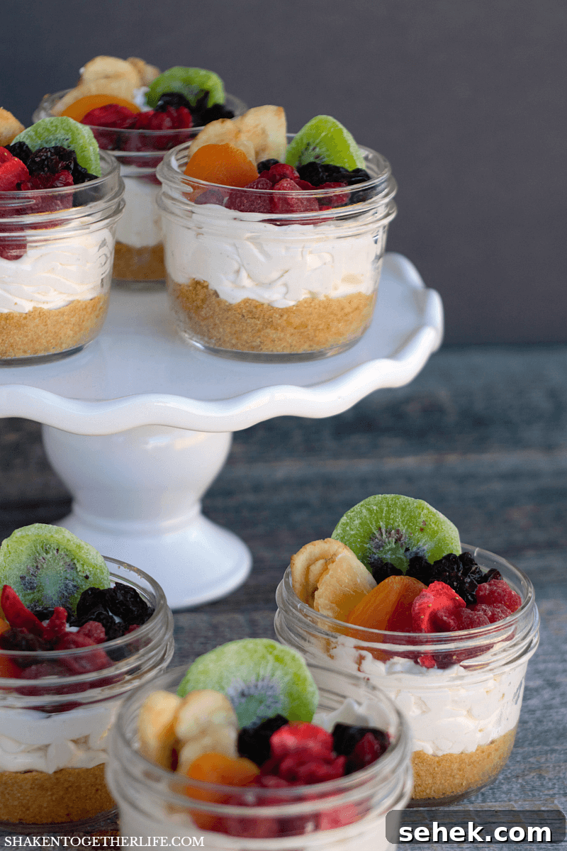 Layered Rainbow Cheesecakes in a Jar: Colorful Mini Dessert Recipe 4 Rainbow Fruit Cheesecakes in a Jar - the prettiest little no bake desserts ever!