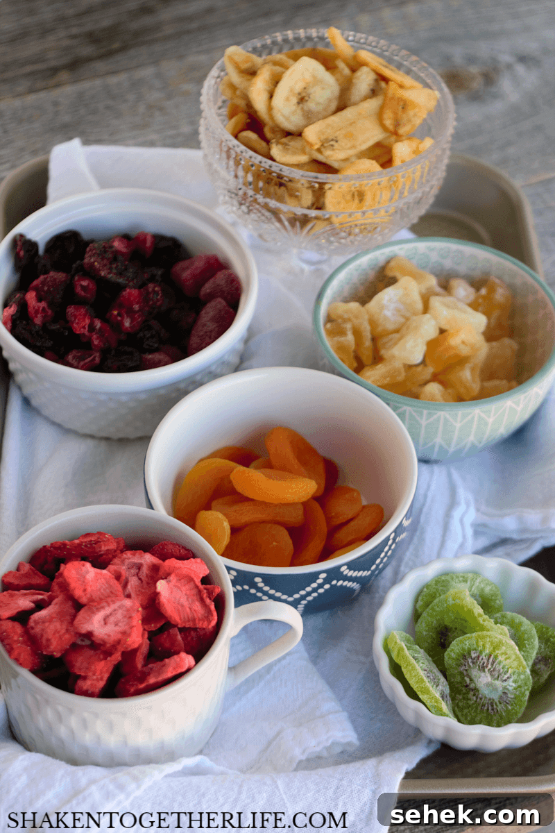 Layered Rainbow Cheesecakes in a Jar: Colorful Mini Dessert Recipe 5 Rainbow Fruit Cheesecakes in a Jar - these no bake cheesecakes wouldn't be the same without colorful dried fruit