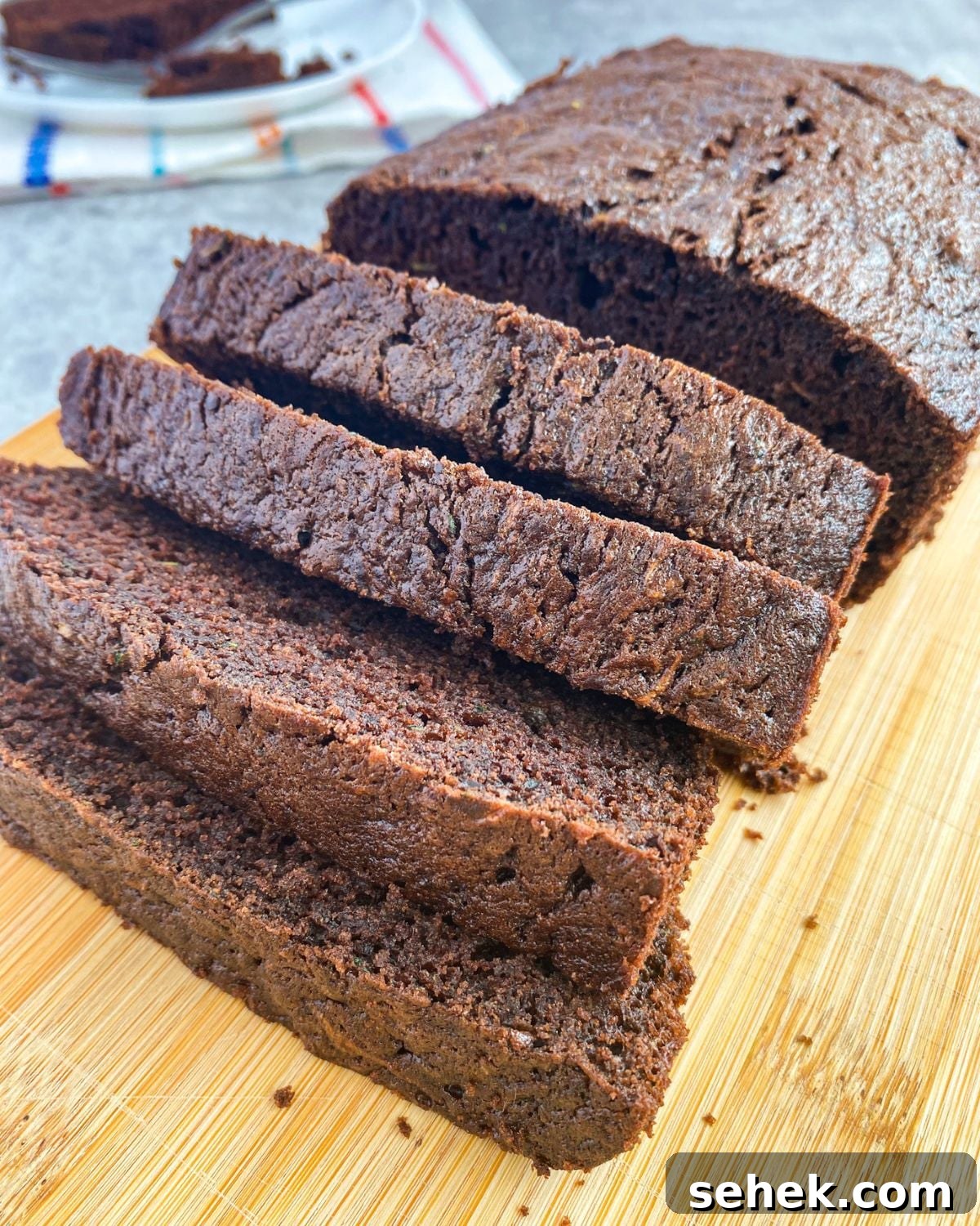 Moist Chocolate Zucchini Bread Recipe You’ll Love 2 Chocolate Zucchini Bread on a cutting board.