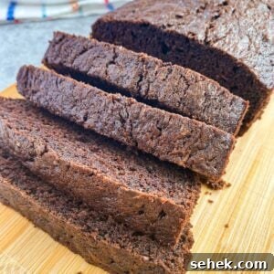 Moist Chocolate Zucchini Bread Recipe You’ll Love 4 chocolate zucchini bread on a cutting board.