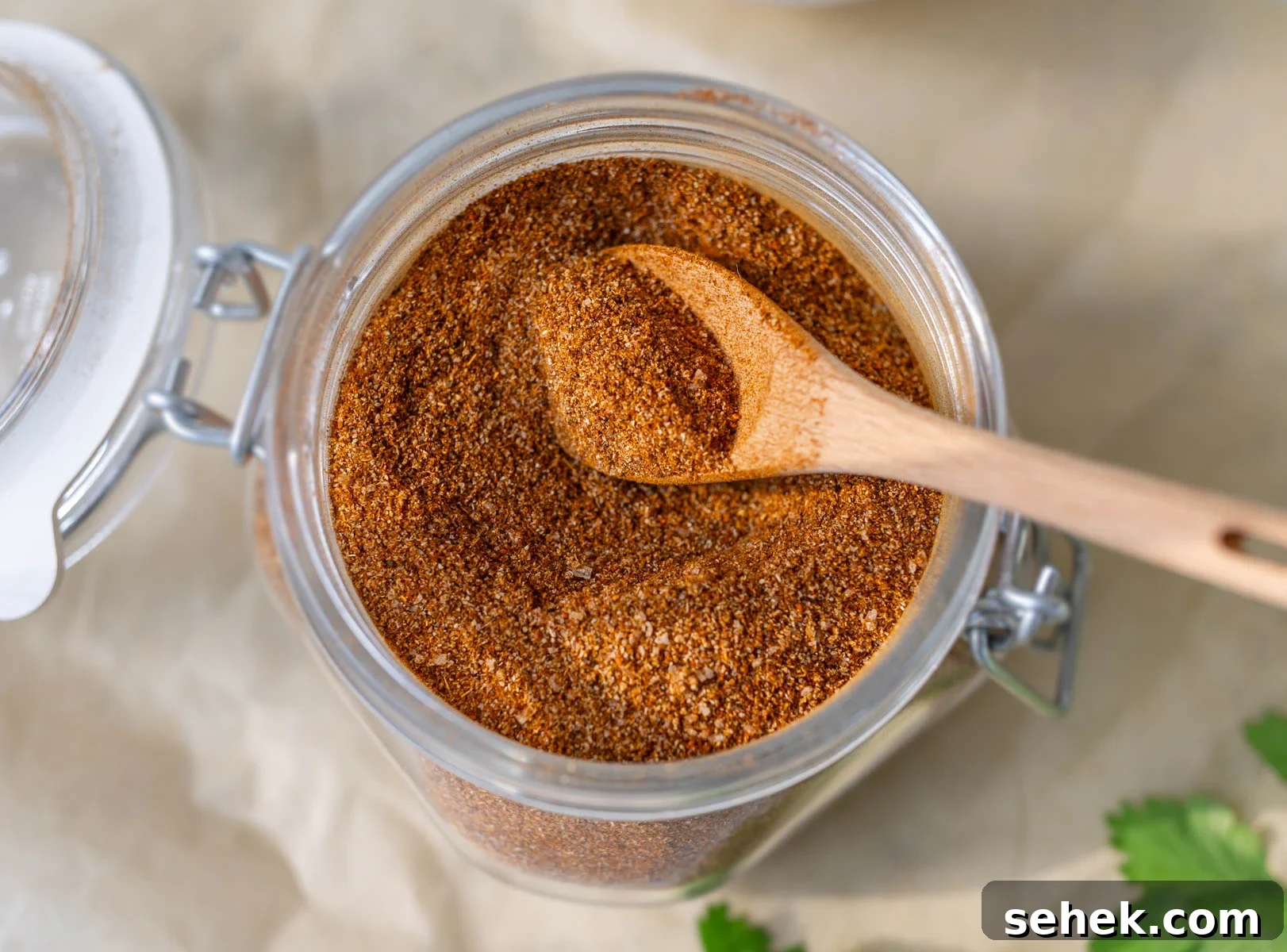 Homemade Taco Seasoning Mix Recipe with Quick Video Guide 2 taco seasoning in a glass spice container with a wooden measuring spoon