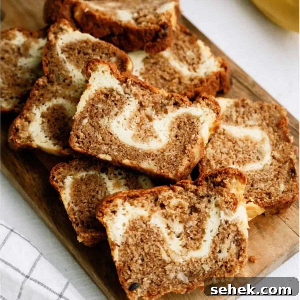 Cream Cheese Banana Bread sliced on a cutting board