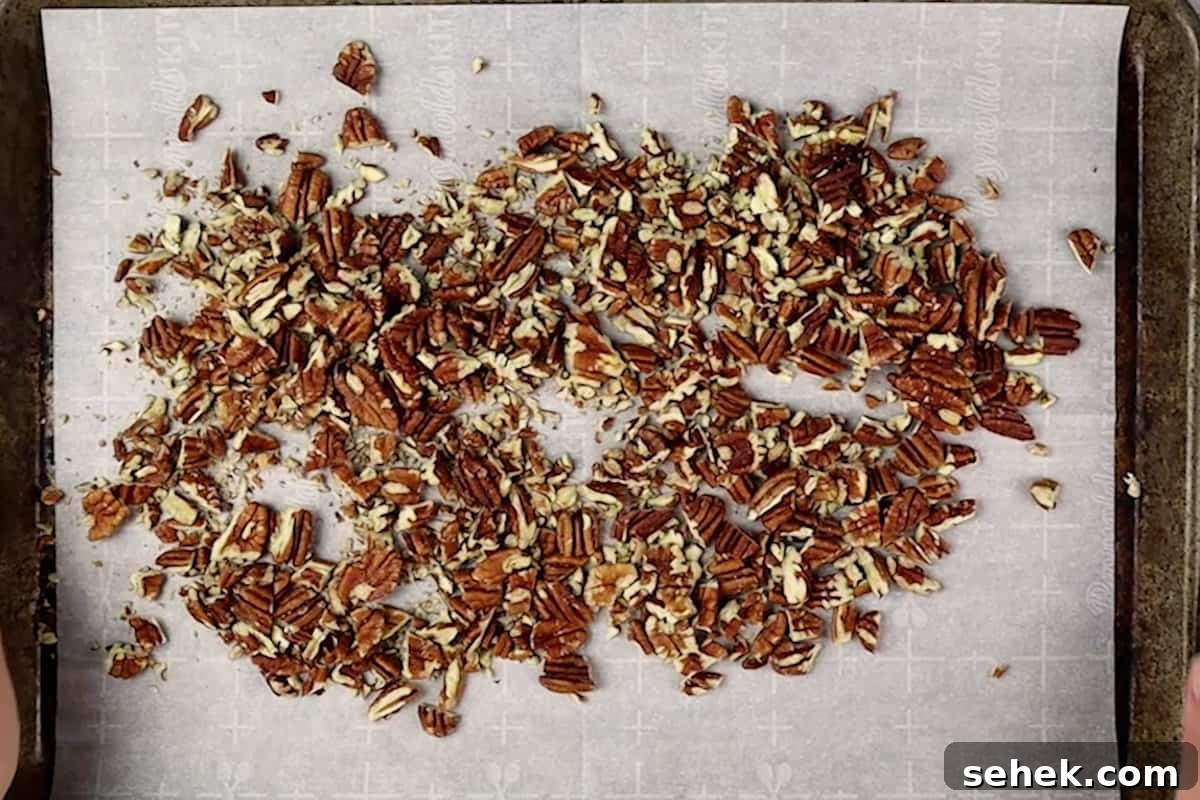 Pecan Pie Cookies: Chewy Cinnamon-Pecan Cookie Recipe 7 toasted pecans on baking sheet.