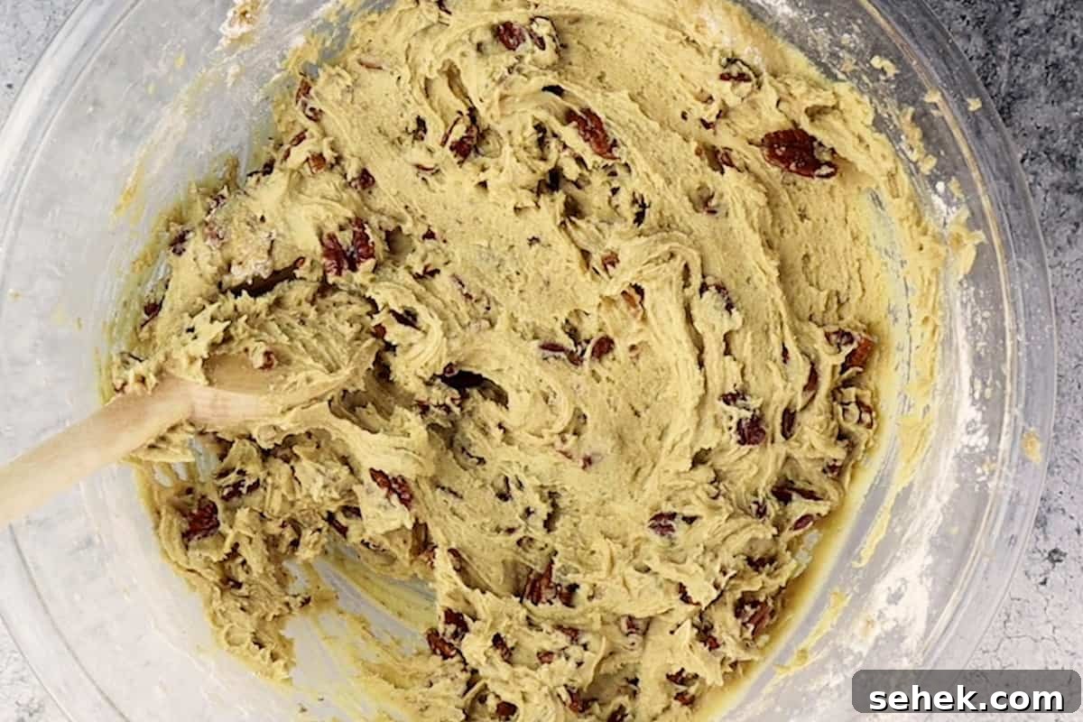 Pecan Pie Cookies: Chewy Cinnamon-Pecan Cookie Recipe 9 pecan pie cookie dough mixed in a glass bowl.