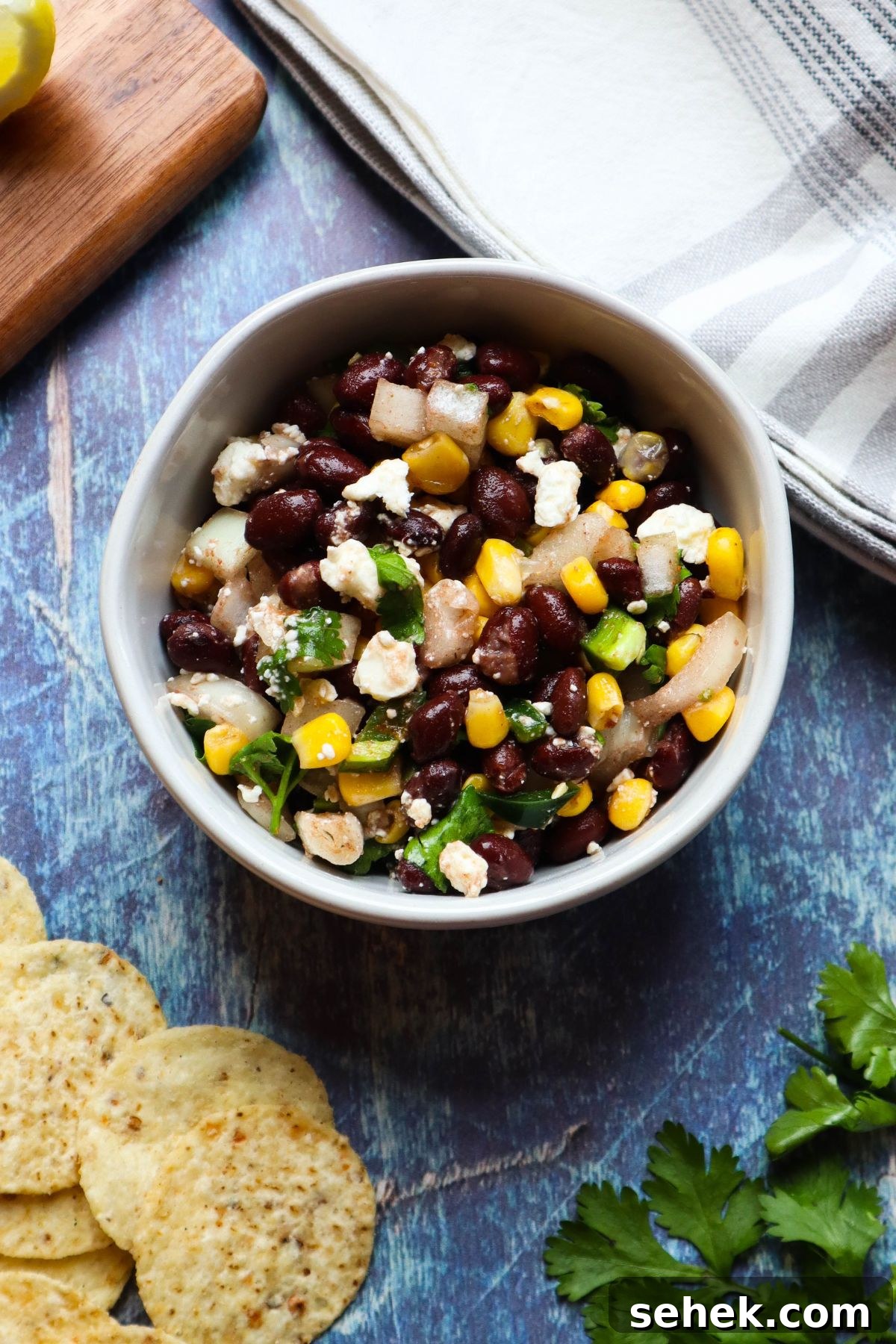 white bowl with black bean corn feta dip.