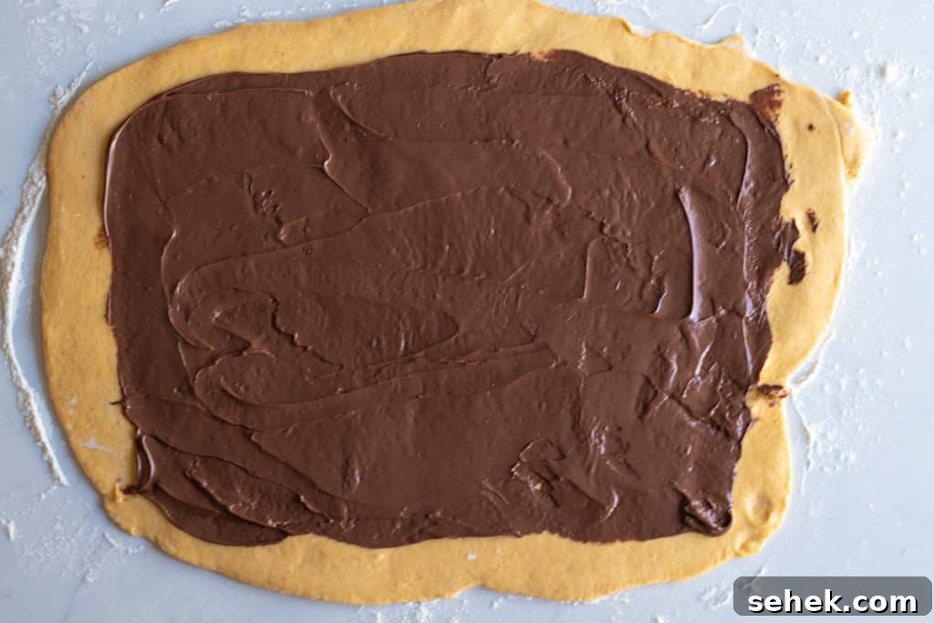 pumpkin babka dough rolled into rectangle and spread with nutella