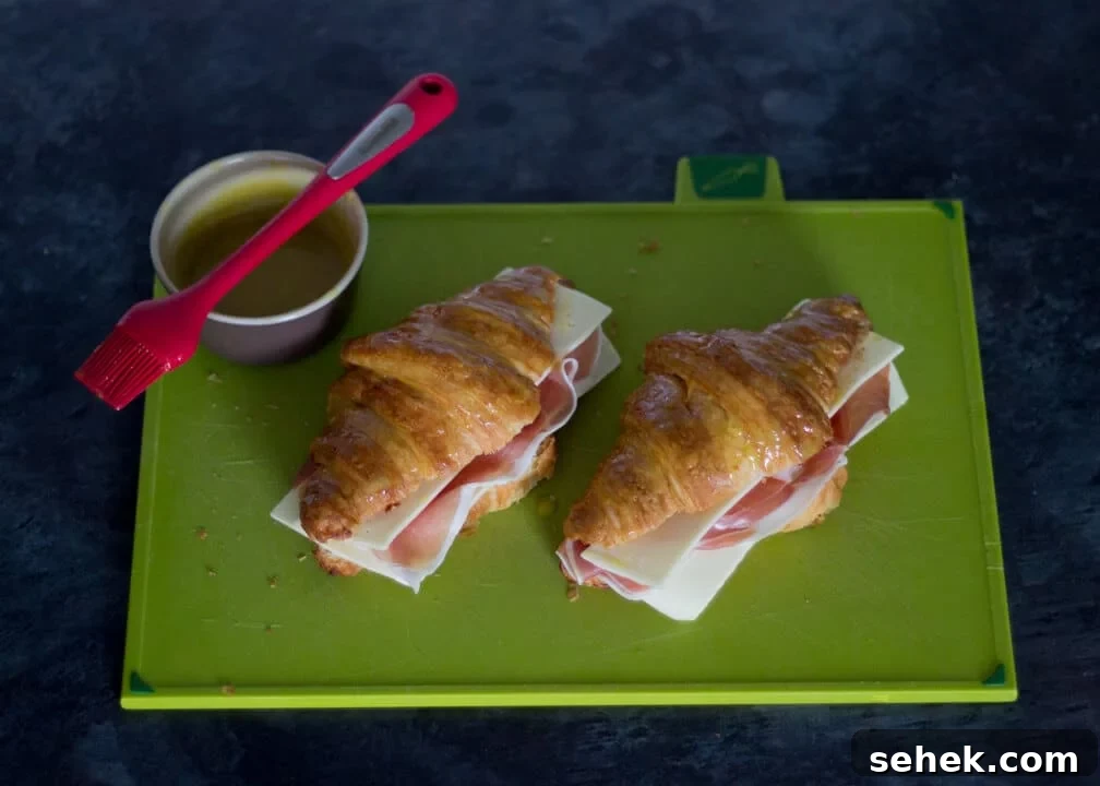 Flaky Croissant Breakfast Sandwich Recipe with Ham & Cheese 6 Croissant Sandwich with Prosciutto & Gouda on a Chopping Board with Mustard Glaze