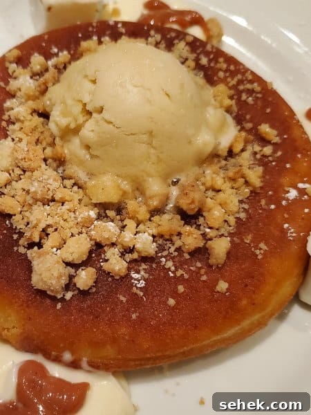pancakes with toppings on a white plate