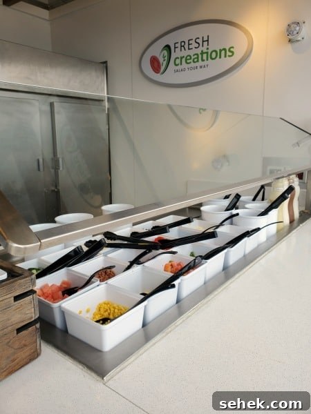 fresh creations sign over a salad bar
