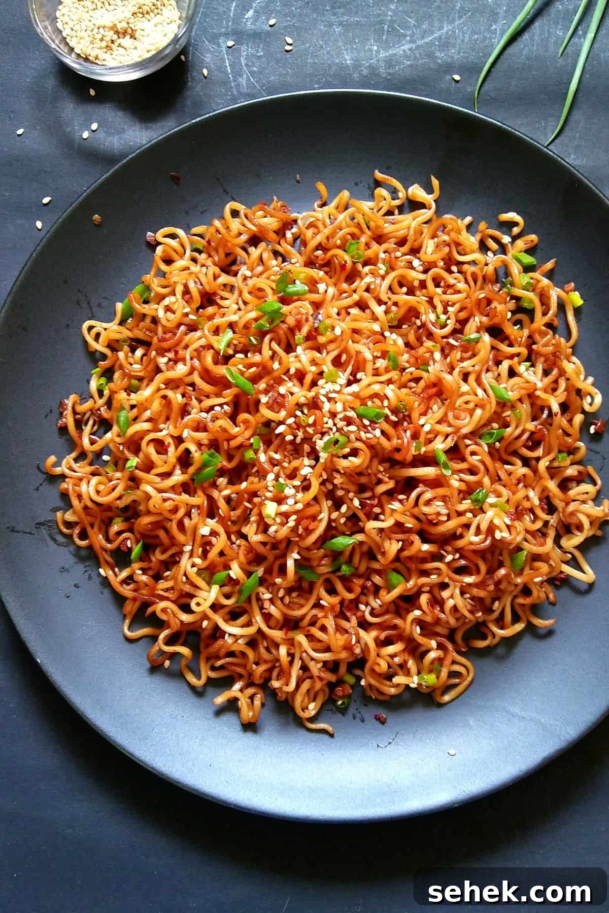 10-Minute Sesame Garlic Ramen Recipe for Fast Flavor 6 Image showing sesame noodles served on a black plate.