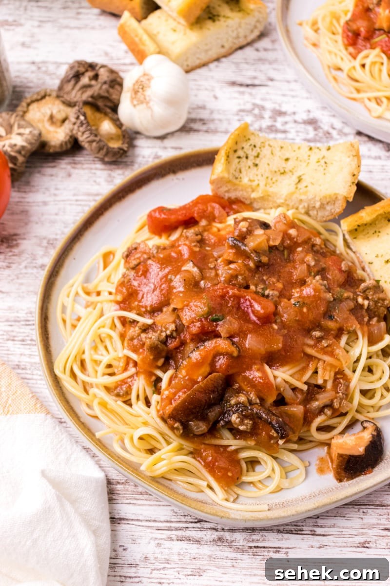 Mom's Spaghetti Sauce spaghetti with sauce and garlic bread on plate