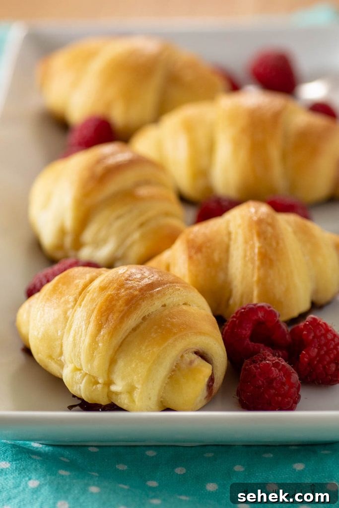 Raspberry Brioche Crescent Pastries: Flaky, Buttery Treats 2 A serving tray of raspberry brioche crescents and fresh raspberries