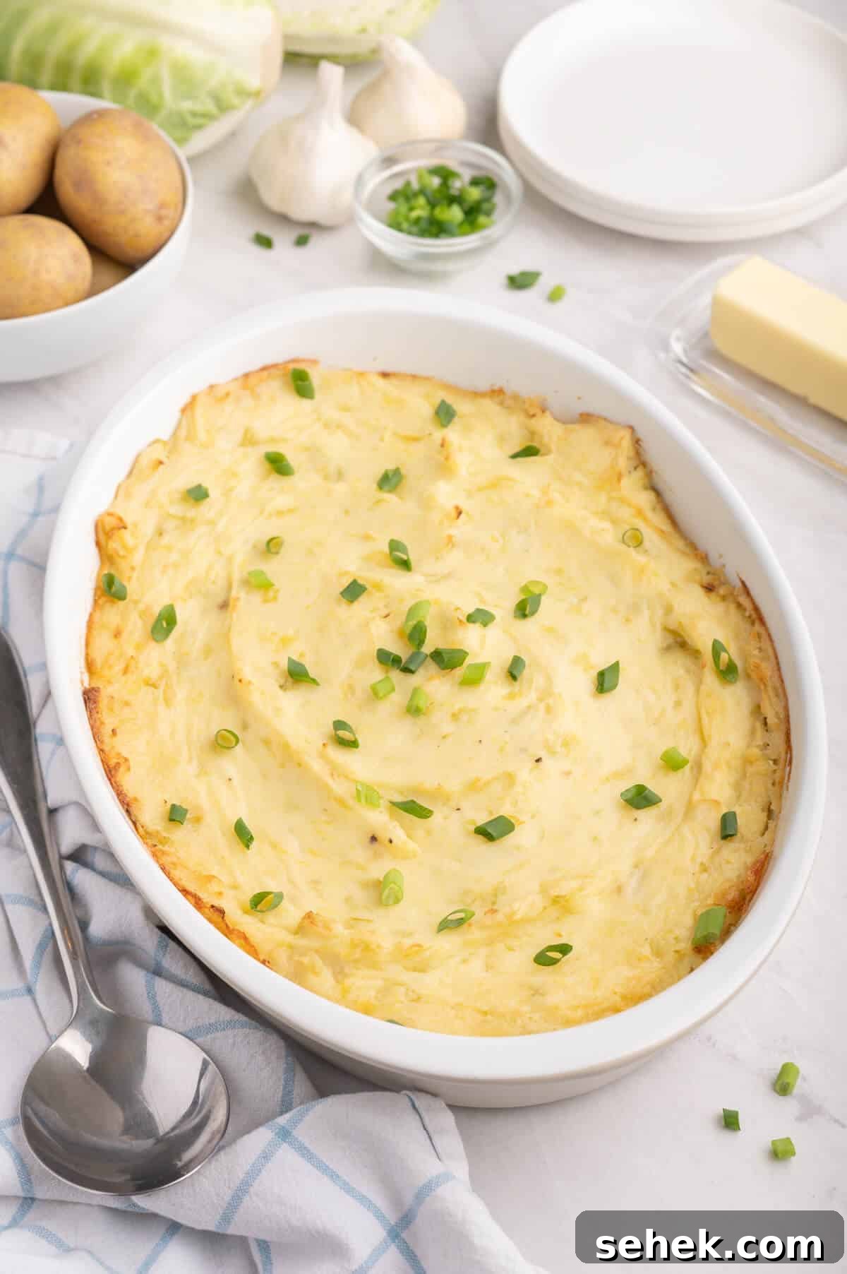 How to Grow and Store Irish Potatoes for Bigger Harvests 2 Irish potatoes in a white casserole dish.