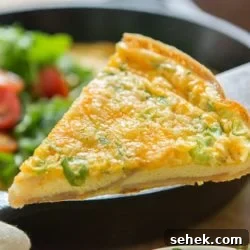 A close up of a slice of Potato Cheddar Frittata