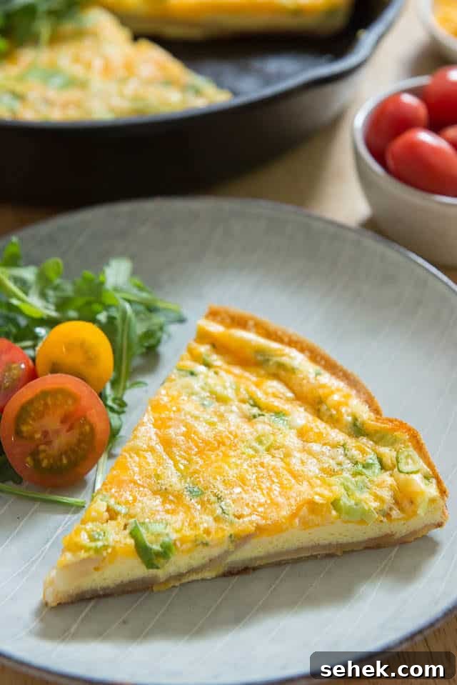Crispy Potato Frittata with Caramelized Onions and Herbs 3 Potato Frittata Recipe - Sliced and Served on Plate with Tomatoes