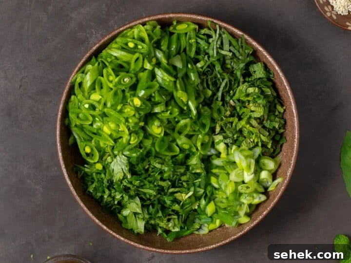 large brown bowl with snap peas and fresh herbs