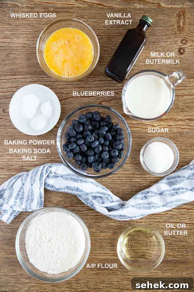 Fluffy Blueberry Pancakes (Made with Frozen Berries) 4 Ingredients to make this blueberry pancake recipe on a wooden table.
