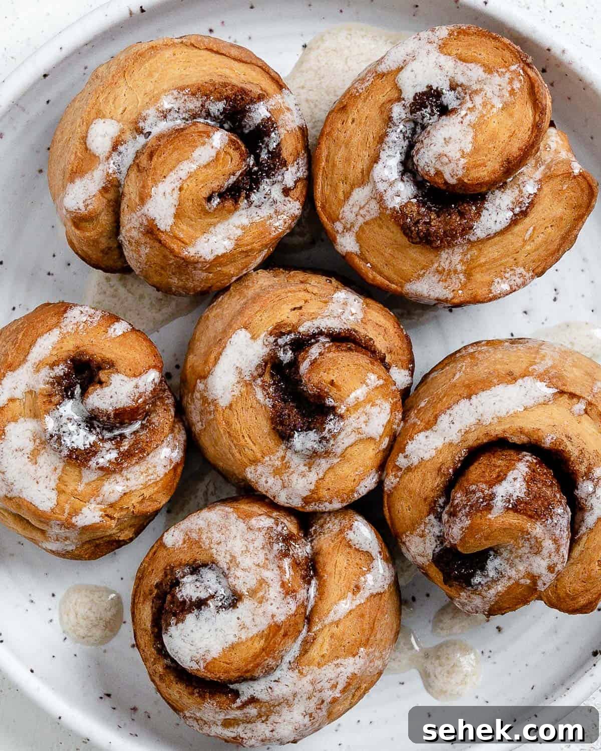 Quick Crescent Roll Cinnamon Buns: 20-Minute Sticky Rolls 2 completed Cinnamon Rolls plated against a white surface