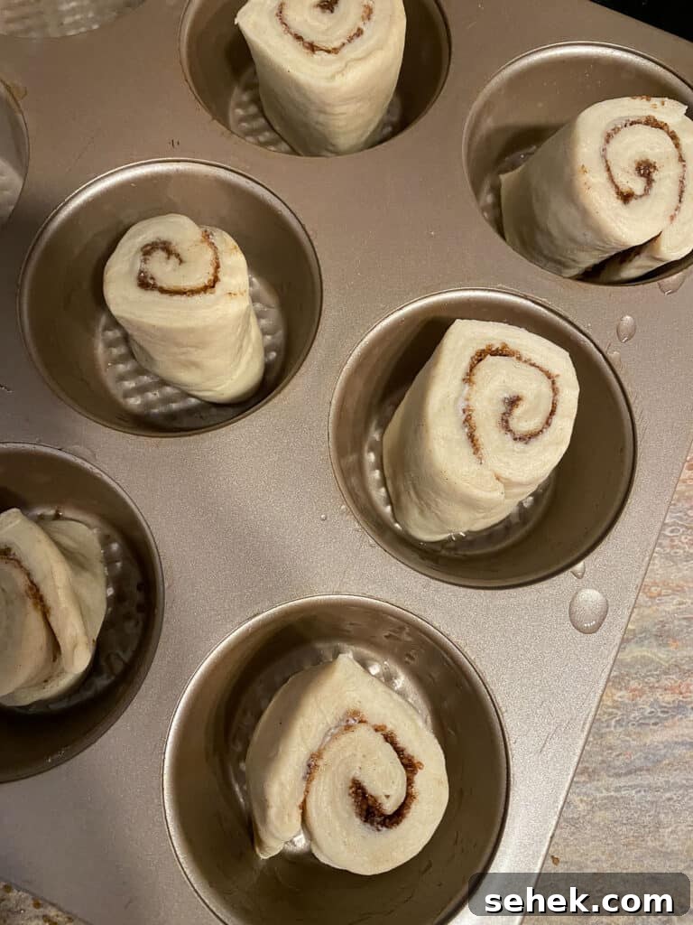 Quick Crescent Roll Cinnamon Buns: 20-Minute Sticky Rolls 12 process shot of adding dough to muffin tin