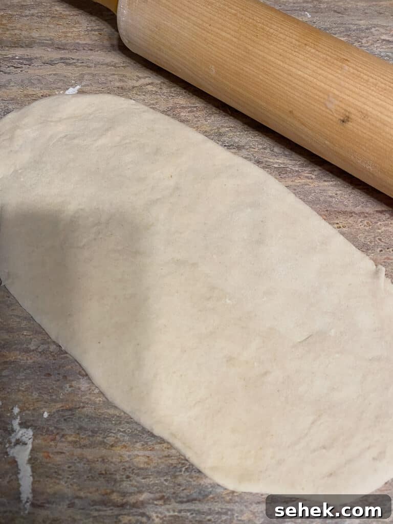 Quick Crescent Roll Cinnamon Buns: 20-Minute Sticky Rolls 5 process shot of flattening out Cinnamon Roll dough against brown surface