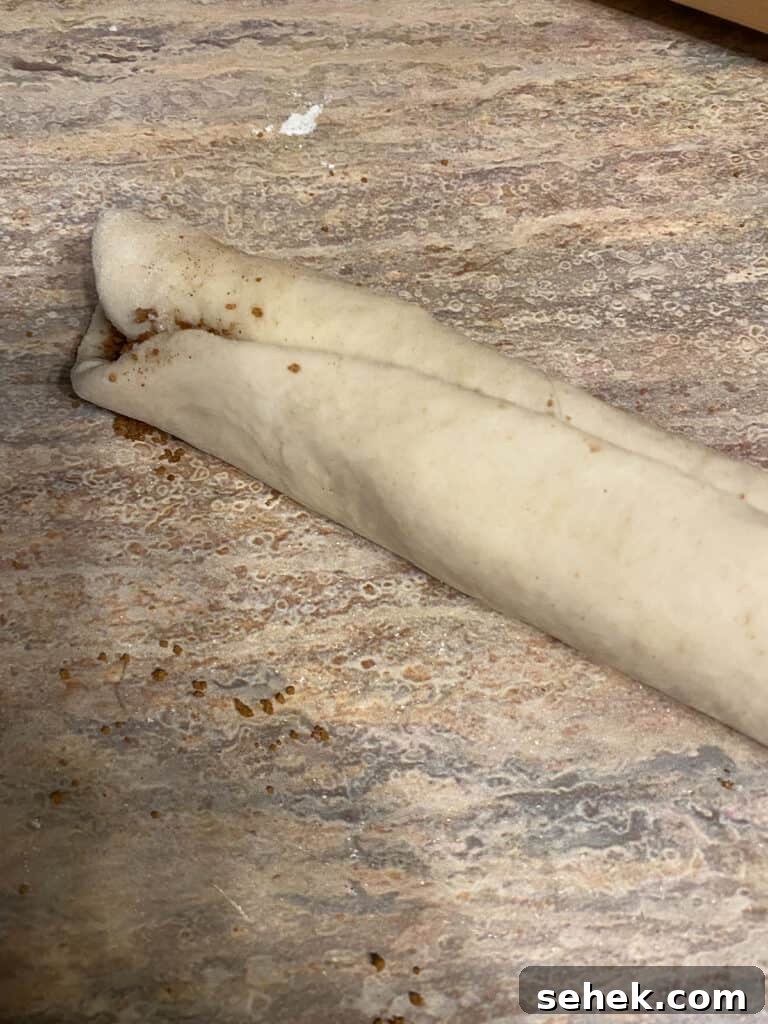 Quick Crescent Roll Cinnamon Buns: 20-Minute Sticky Rolls 10 process shot showing cinnamon roll rough rolled up