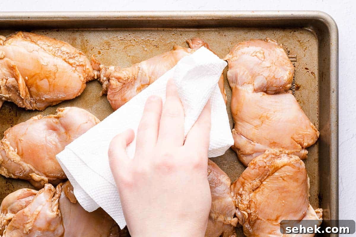 Balsamic Grilled Chicken with Garlic and Herbs 7 chicken on tray being patted dry with paper towels
