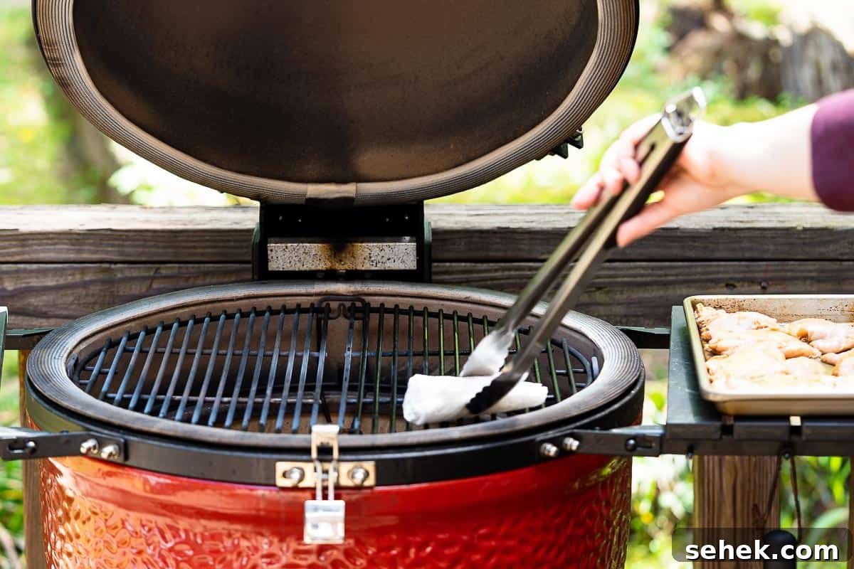 Balsamic Grilled Chicken with Garlic and Herbs 8 tongs holding paper towel oiling grill grates