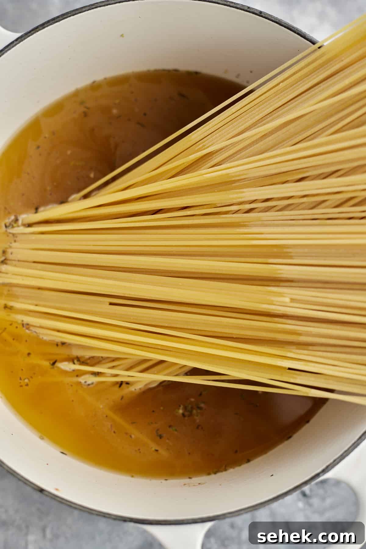 One-Pot Spaghetti Carbonara: Quick Creamy Classic Recipe 6 spaghetti noodles in a pot with broth to make spaghetti carbonara