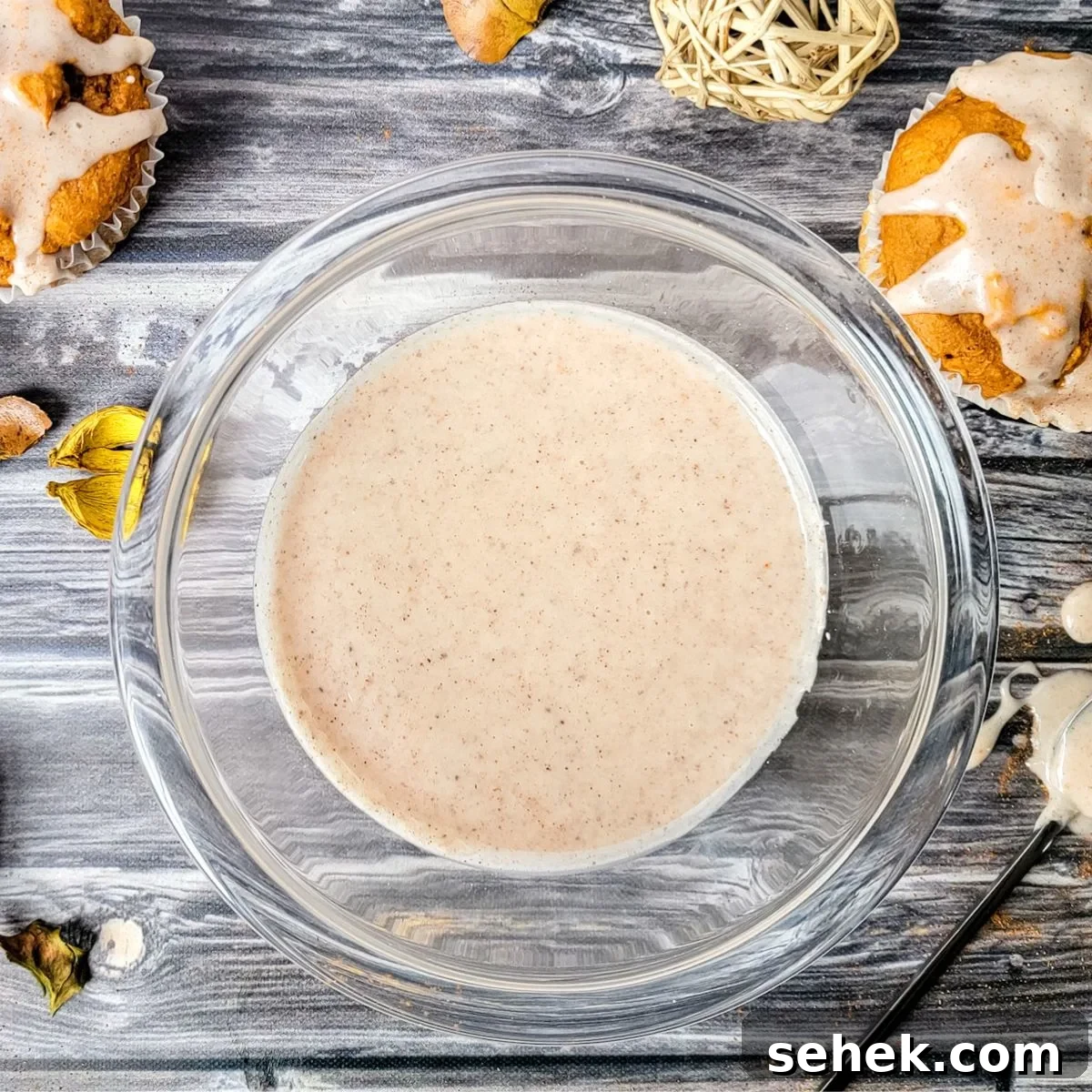A glass bowl of gluten and dairy free sugar and cinnamon glaze for muffins.